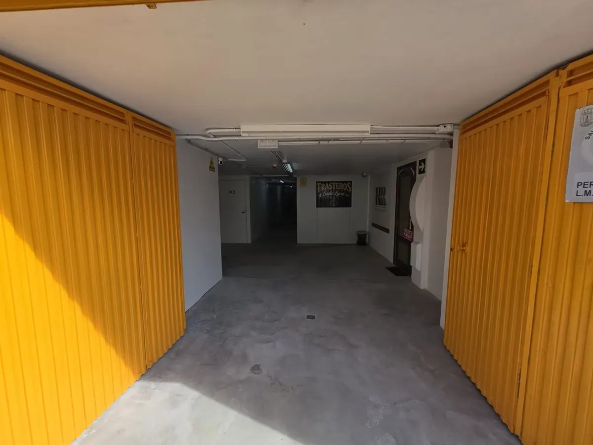 Entrada interior con puertas amarillas del local de trasteros